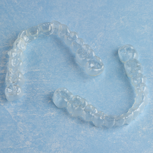 Clear Blue Smiles clear aligners shown on blue background