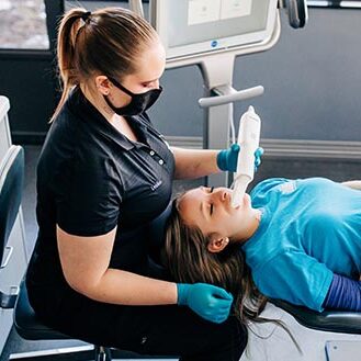 Clear Blue Smiles patient in the chair of a Smile Center orthodontist